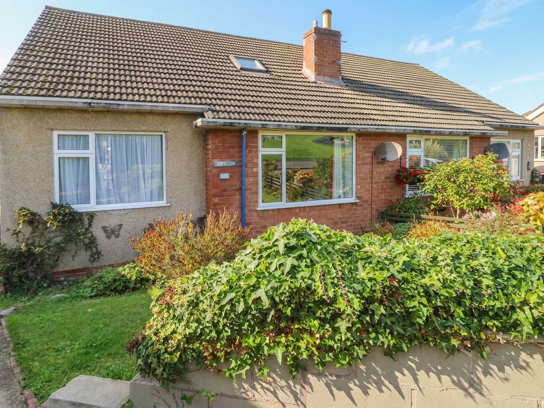 A house with windows and a garden at Awelon in Rhos-On-Sea