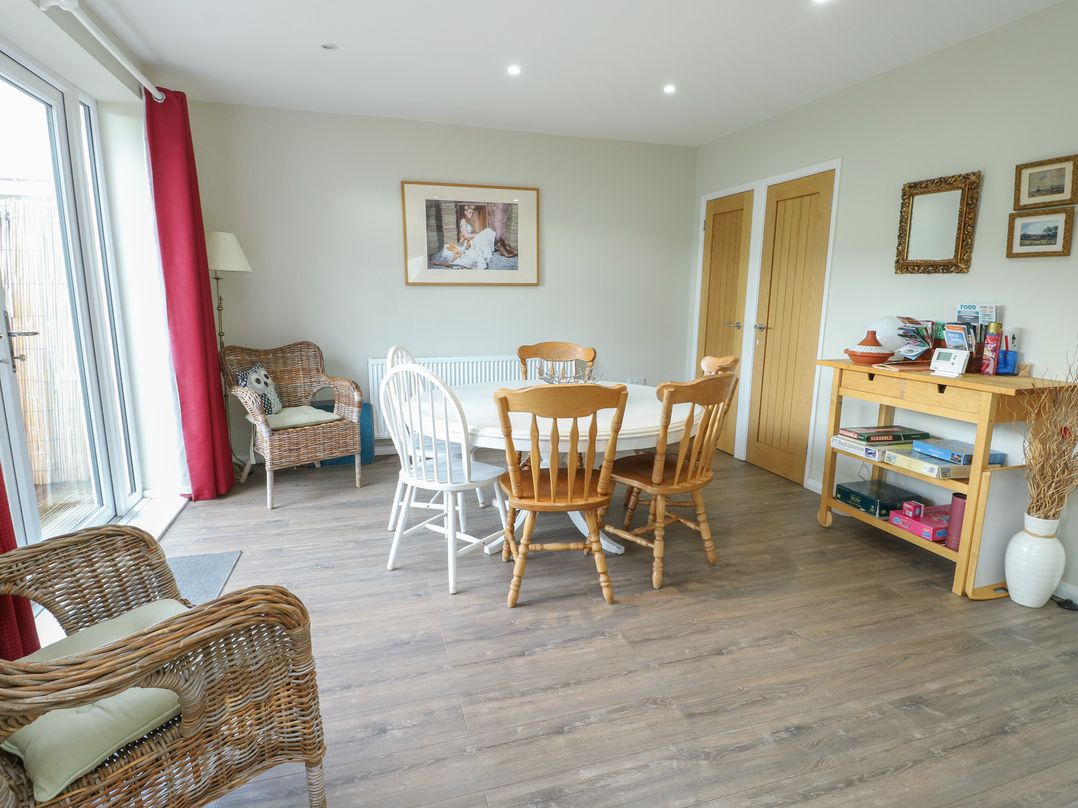 A dining room with a table and chairs at Awelon in Rhos-On-Sea