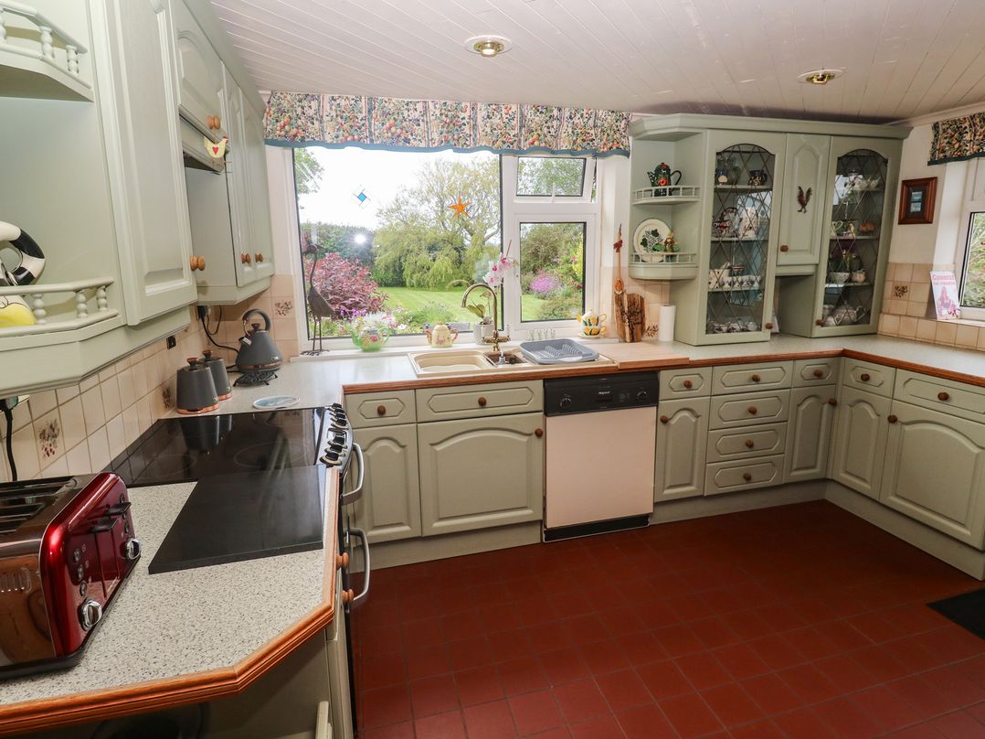 A kitchen with stoves and a sink at Woolly Welcome in Goldsithney