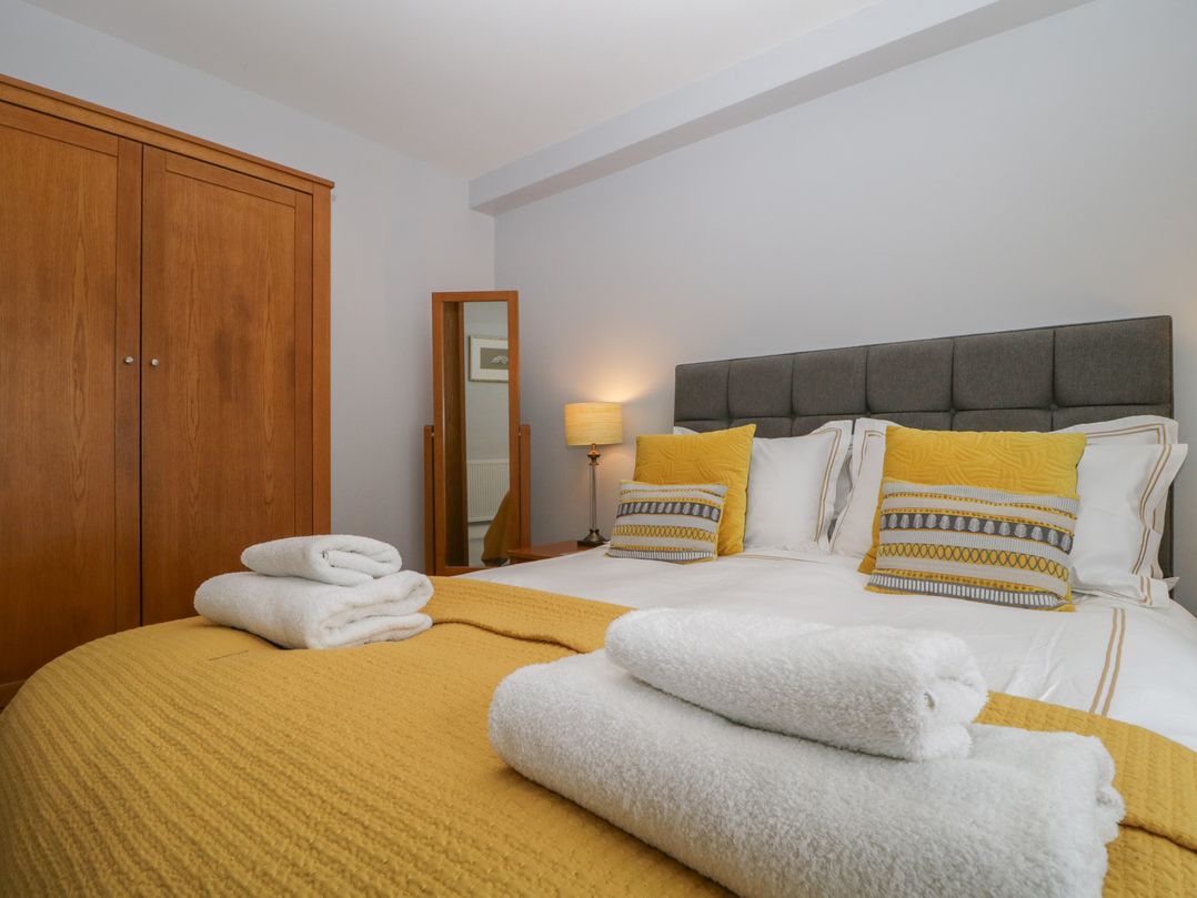 A bedroom with a bed and wardrobe at High Spy in Keswick