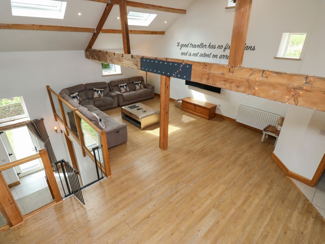 A living room with a sofa and coffee table at Upper House Barn in Delph