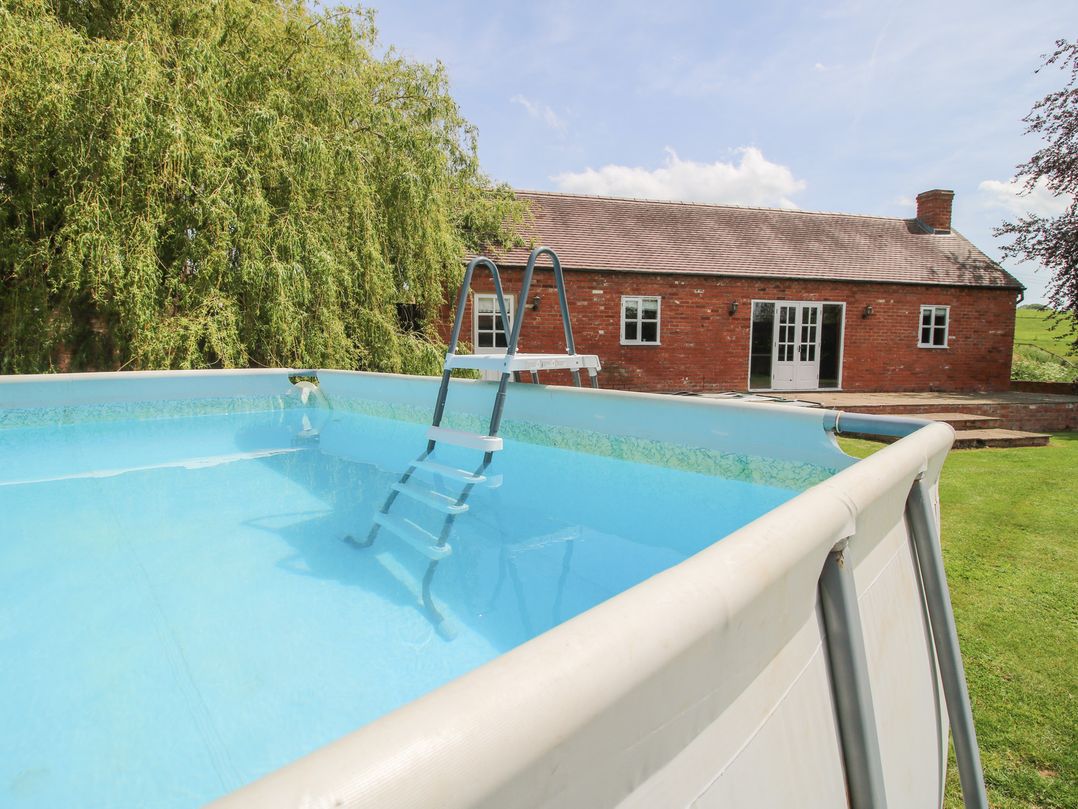 A swimming pool with a ladder at Hilltop House in Tenbury Wells