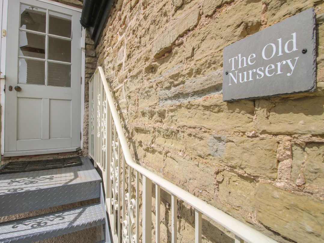 An entrance with stone wall and steps to The Old Nursery in Bourton near Much Wenlock