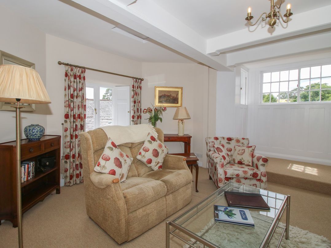 A living room with a sofa and armchair at The Old Nursery in Bourton near Much Wenlock