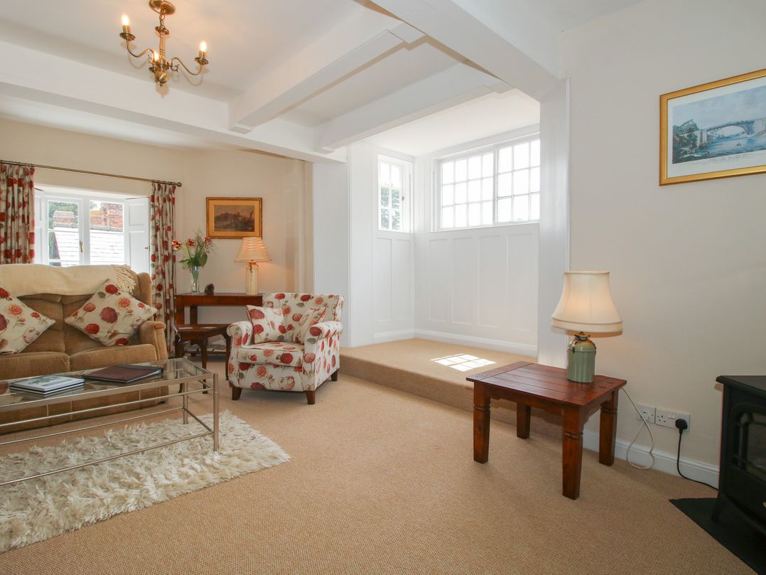 A living room with a sofa and armchair at The Old Nursery in Bourton near Much Wenlock