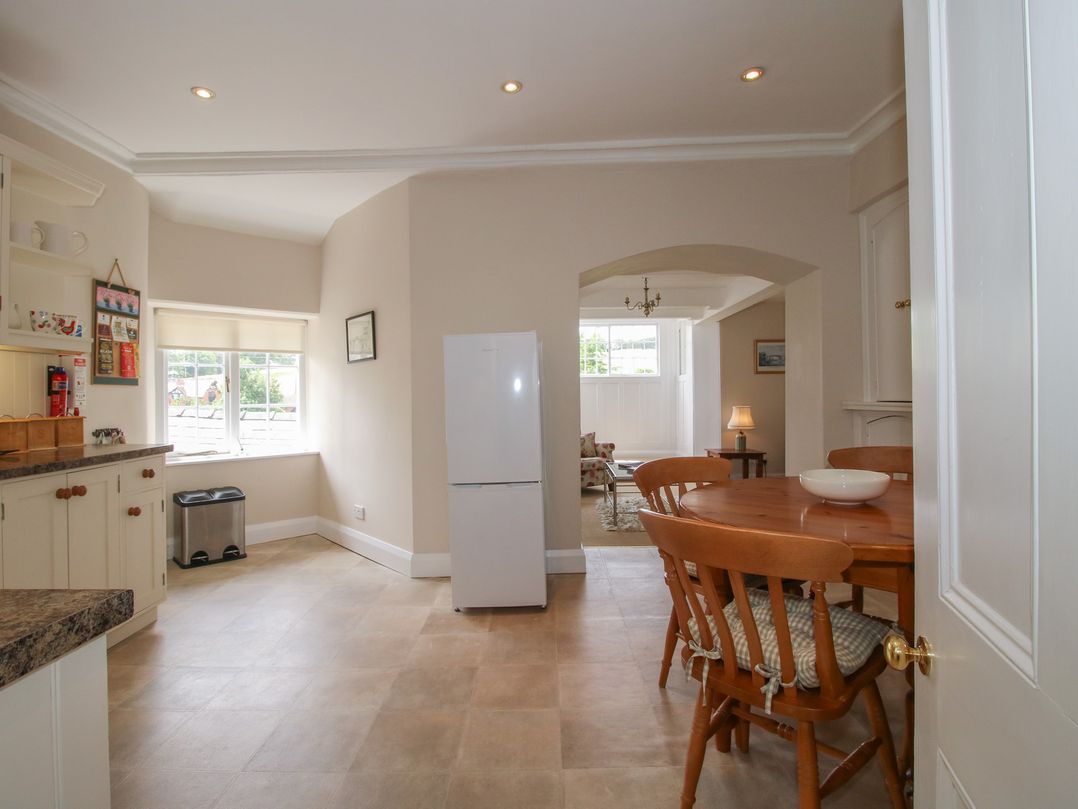A kitchen with a table and chairs at The Old Nursery in Bourton near Much Wenlock