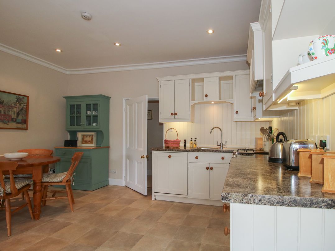 A kitchen with a table and chairs at The Old Nursery in Bourton near Much Wenlock