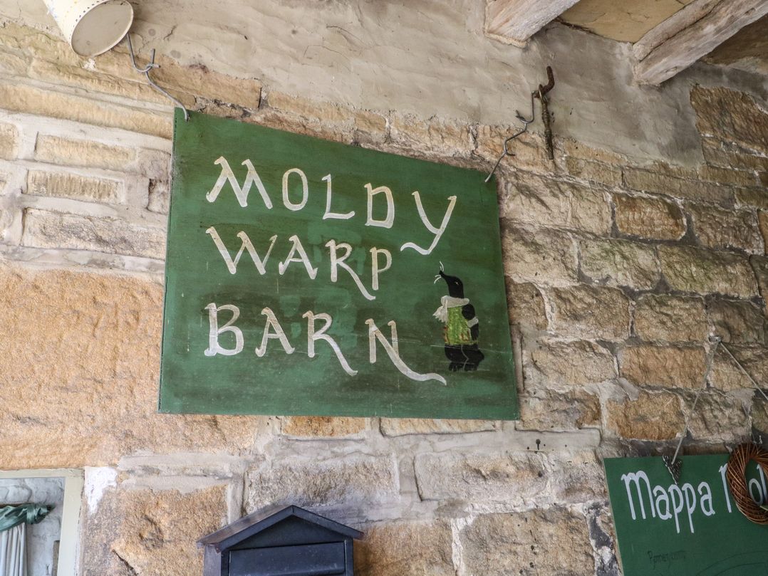 A sign indicating Moldy Warp Barn at Moldy Warp Barn in Haworth