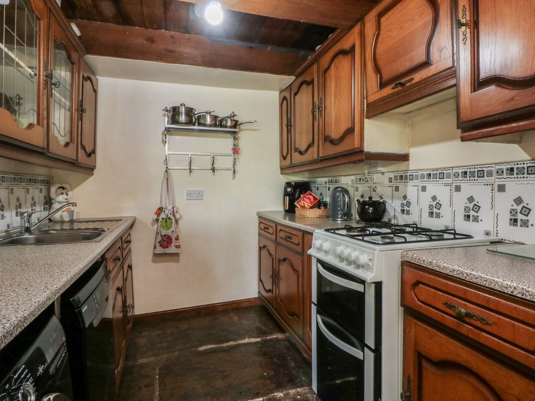 A kitchen with cabinets and stove at Moldy Warp Barn in Haworth
