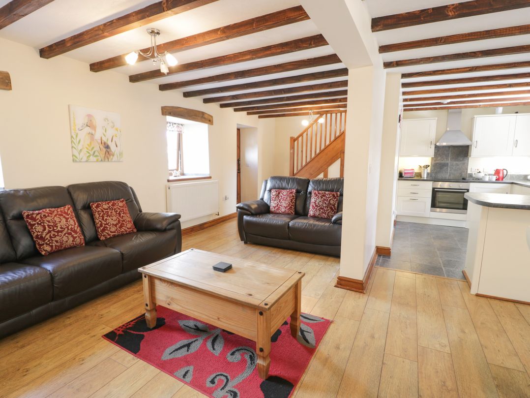 A living room with a coffee table and sofas at Stabal-y-Gwedd in Dolwen near Abergele