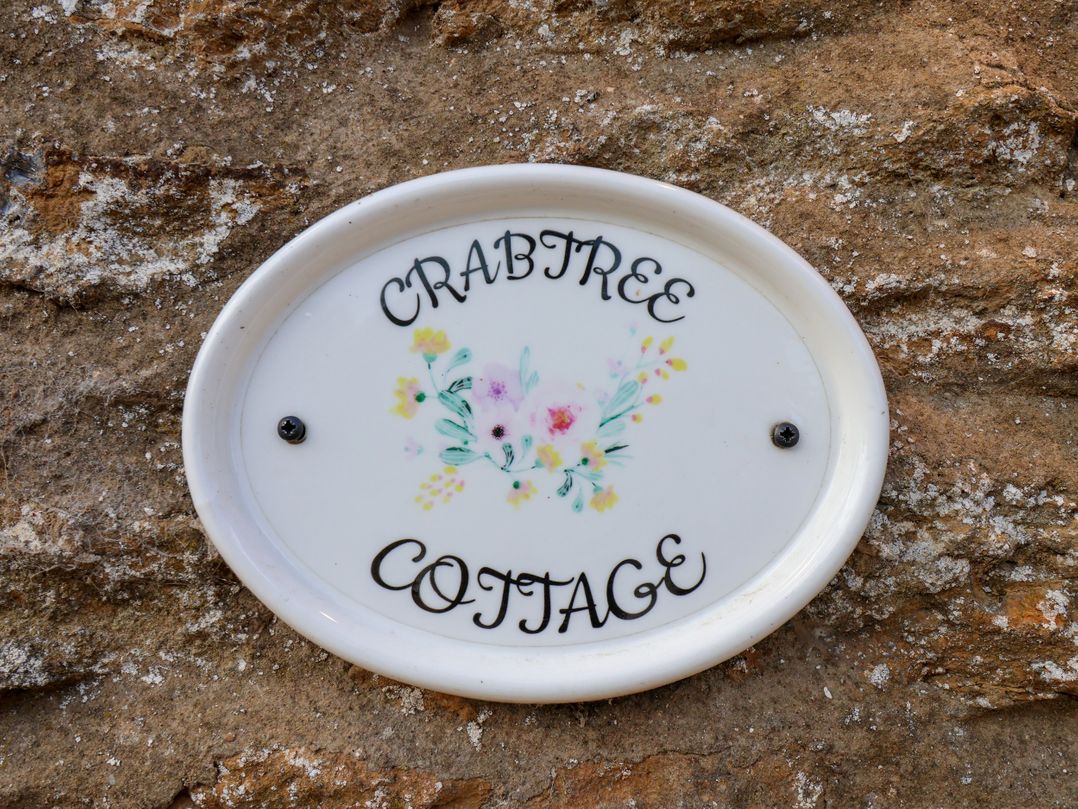 A nameplate on a stone wall at Crabtree Cottage in Suffield near Scalby