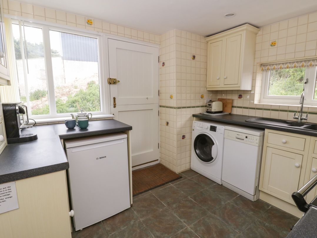 A kitchen with appliances and a sink at Little Barn Cottage Dinas Cross Pembrokeshire