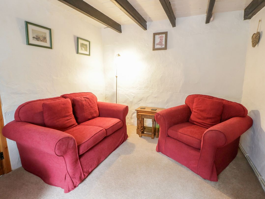 A living room with a sofa and an armchair at Panteg, Cardigan Llangoedmor Cardigan