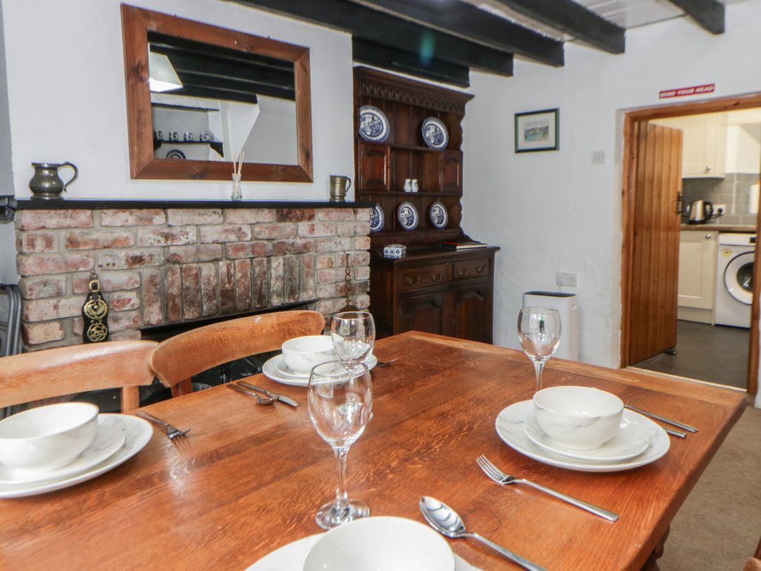 A dining room with a table set for dinner at Panteg, Cardigan Llangoedmor Cardigan