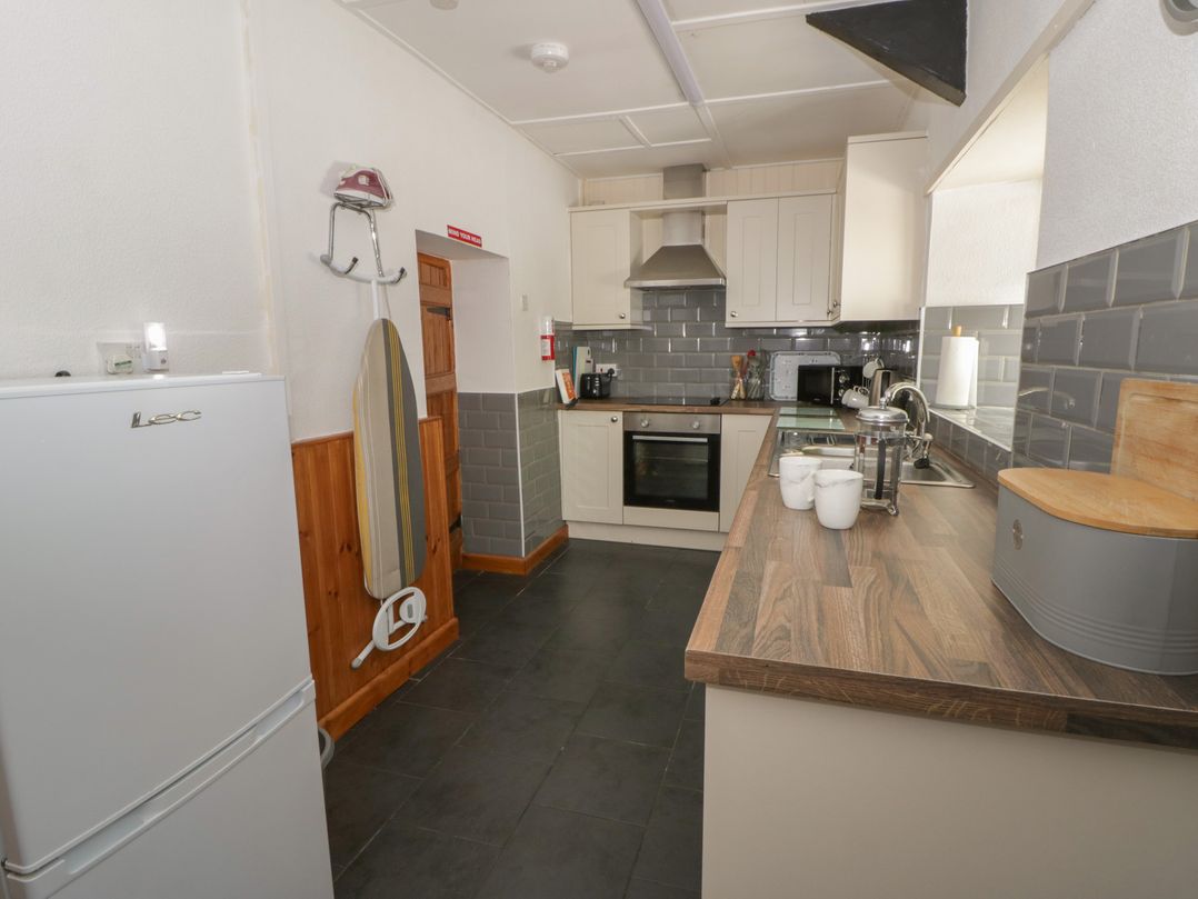 A kitchen with refrigerator, oven, and sink at Panteg, Cardigan Llangoedmor Cardigan