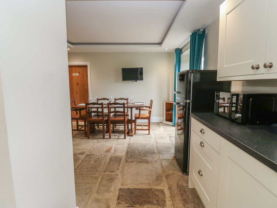 A kitchen with a dining table and chairs at White Lea in Reeth