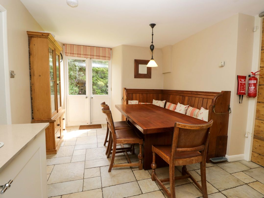 A dining room with a wooden table and chairs at Chapel How in Ambleside