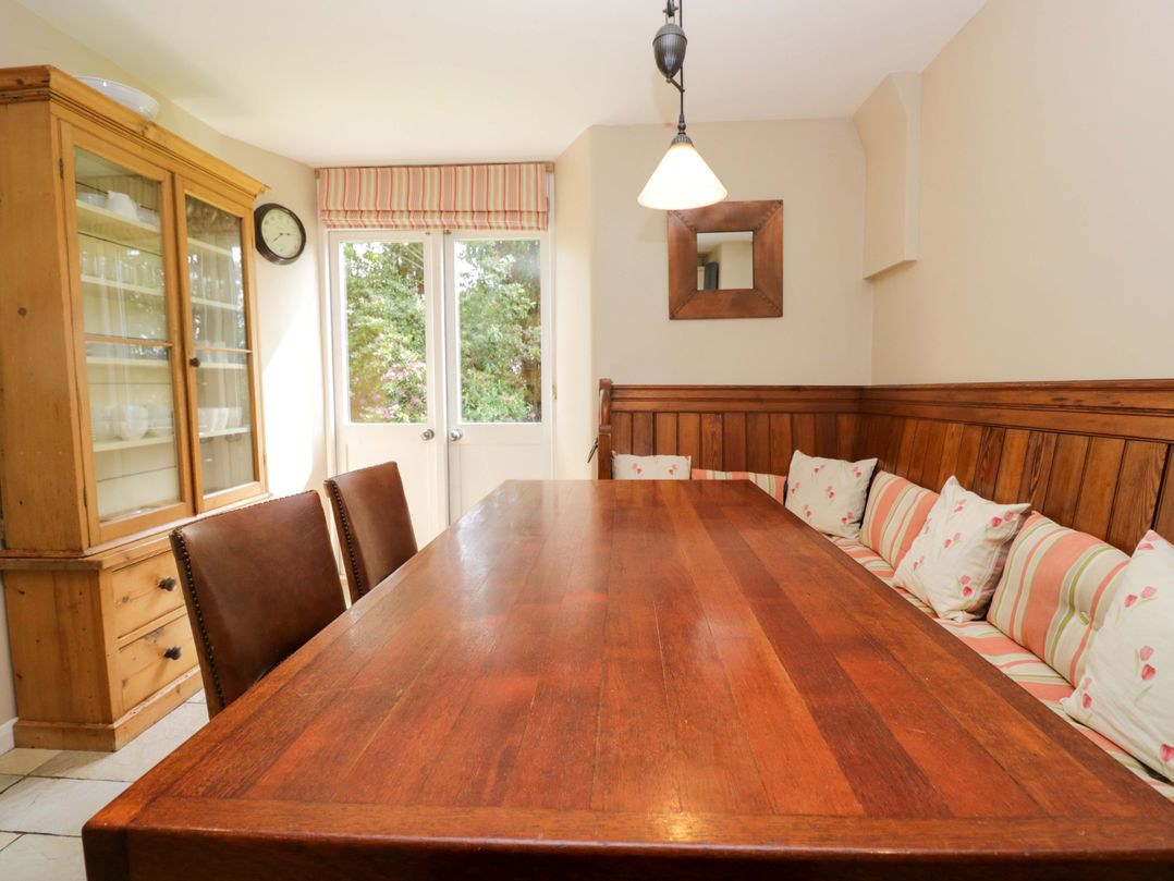 A dining room with a wooden table and chairs at Chapel How in Ambleside