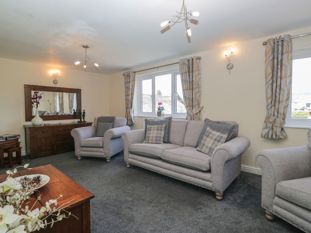 A living room with sofas and a coffee table at Woodside West in Bowness