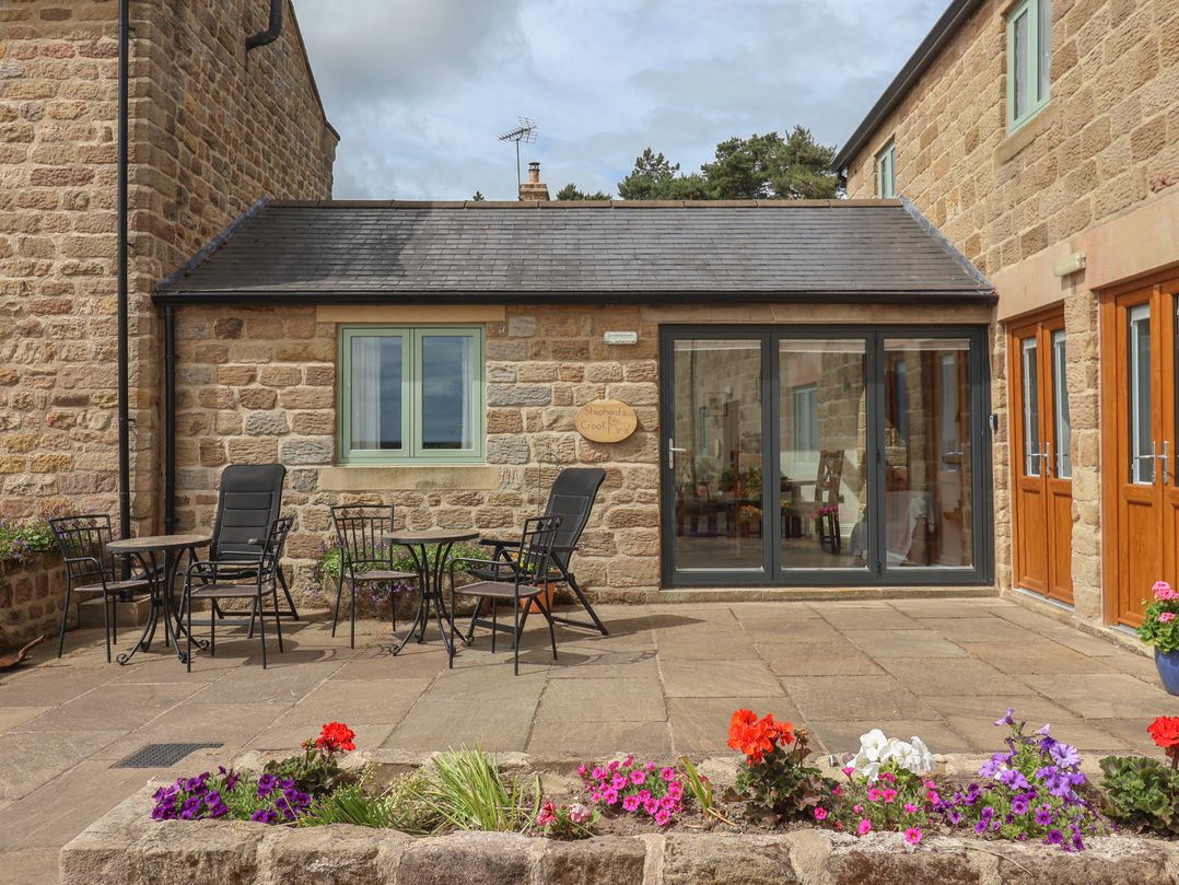 An outdoor seating area with chairs and a table at Shepherd's Crook in Follifoot near Spofforth