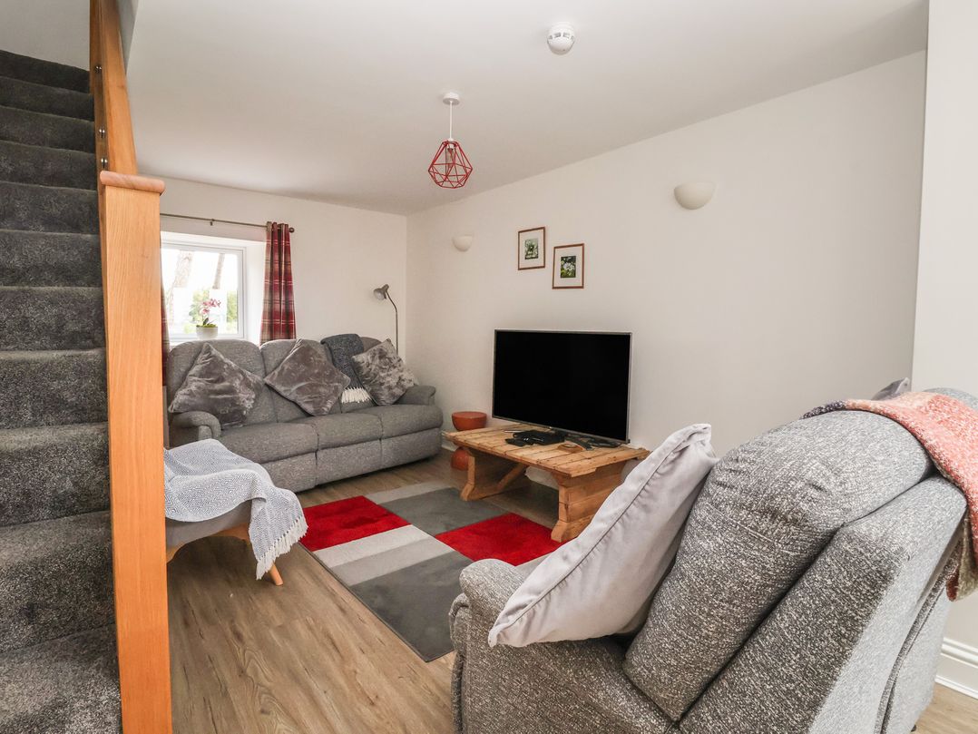 A living room with a sofa and television at Shepherd's Crook in Follifoot near Spofforth