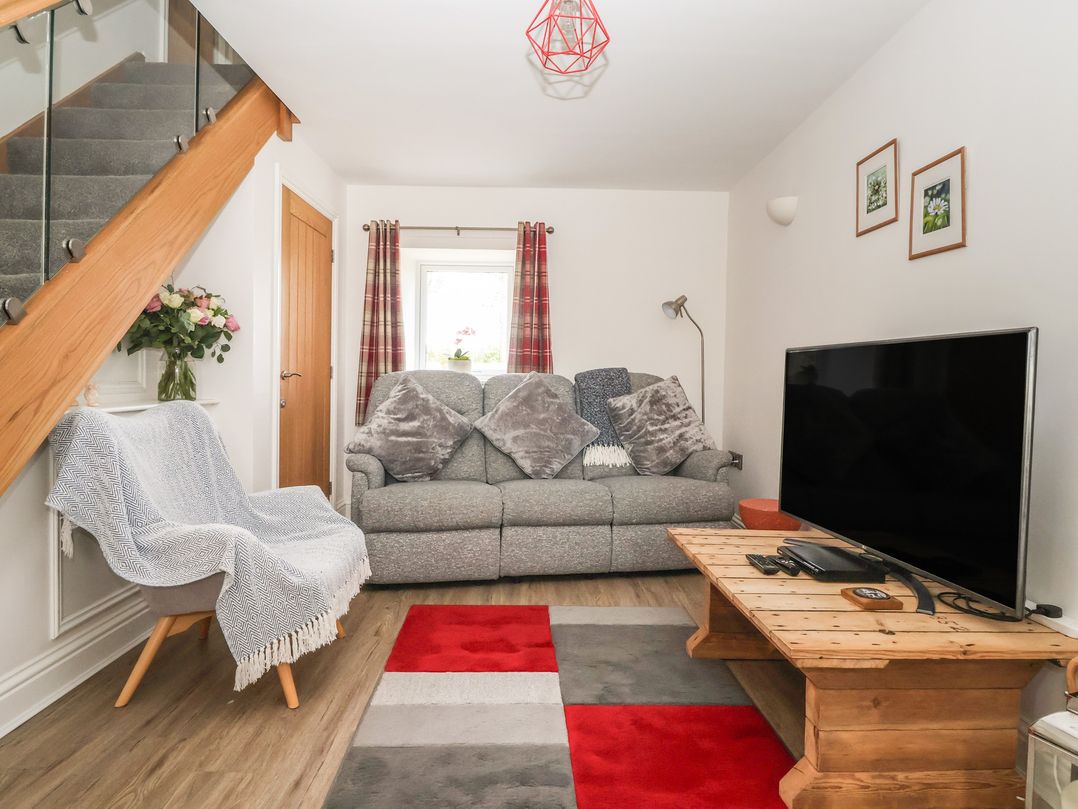 A living room with a sofa and television at Shepherd's Crook in Follifoot near Spofforth