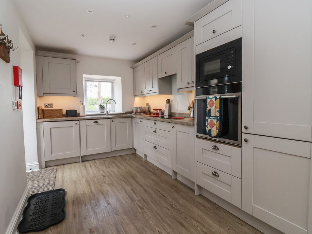A kitchen with cabinets and a sink at Shepherd's Crook in Follifoot near Spofforth