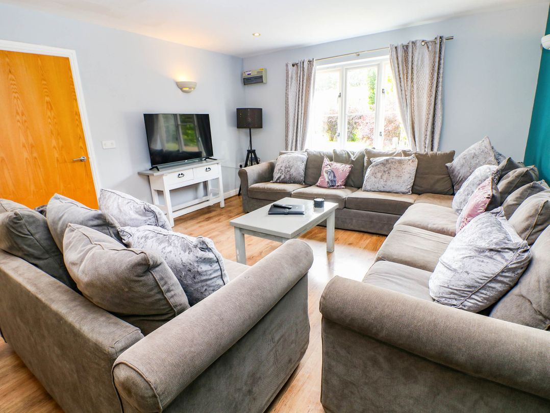 A living room with sofas and a television at Hassop in Matlock