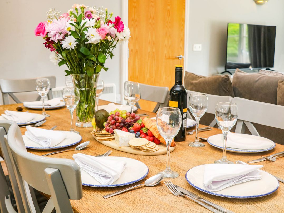 A dining room with a table set for a meal at Hassop in Matlock