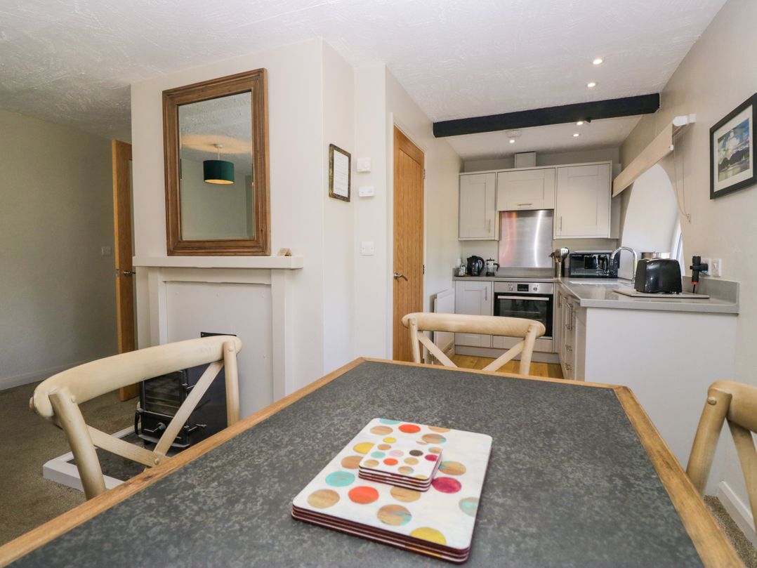 A dining area with a table and chairs at Windermere at the Graythwaite Estate near Hawkshead