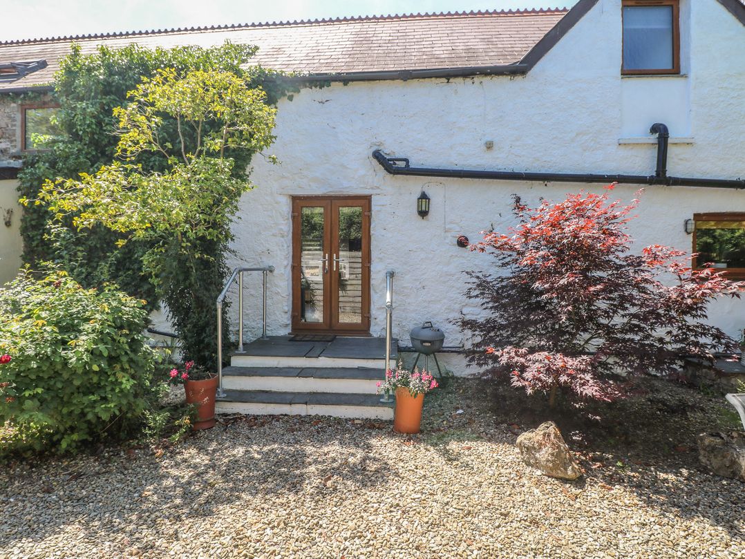 An entrance with steps and plants at Stable Cottage, Templeton near Narberth