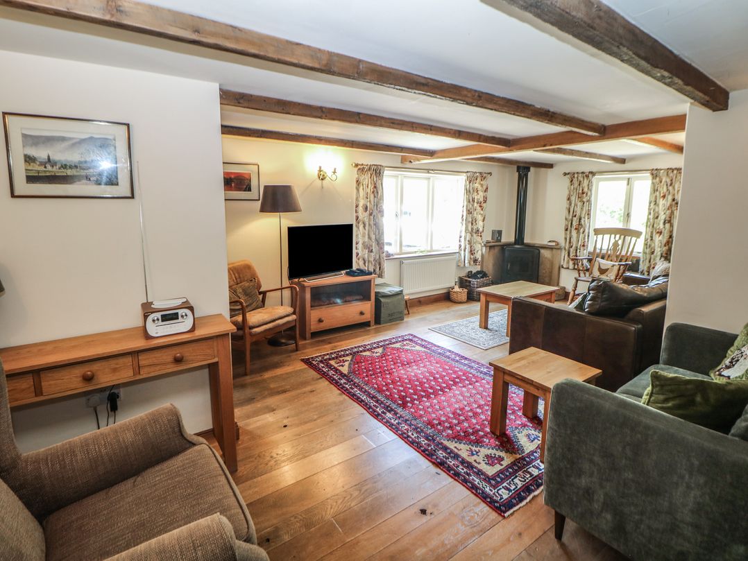 A living room with a television and seating arrangements at Green Farm Stables in Hognaston near Carsington Water