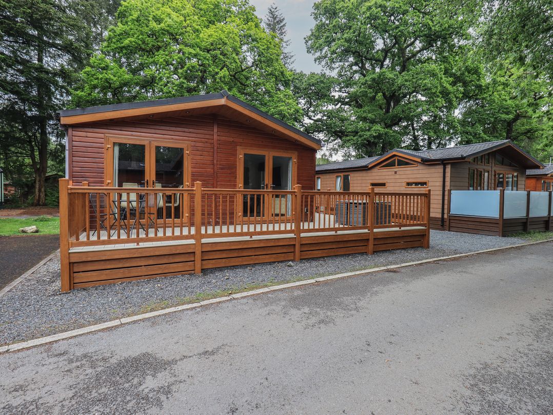 A cabin with a decking and railing at Ridgway Lodge, Calgarth 40, White Cross Bay near Windermere