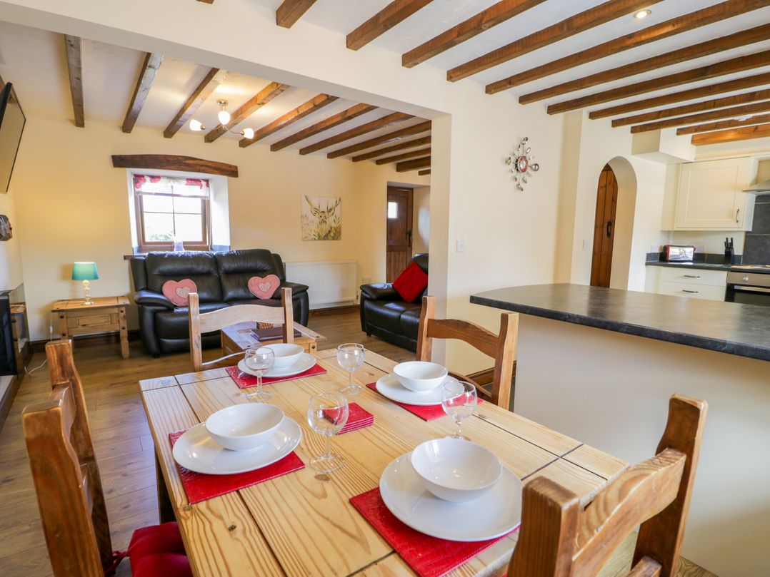 A dining area with table and chairs at Bwthyn Y Wennol Dolwen near Abergele