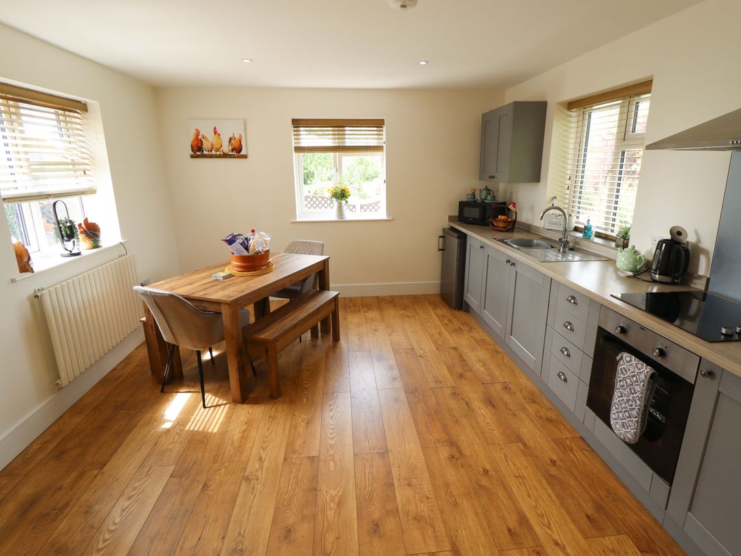 A kitchen with a dining table and chairs at The New Build in South Reston near Louth