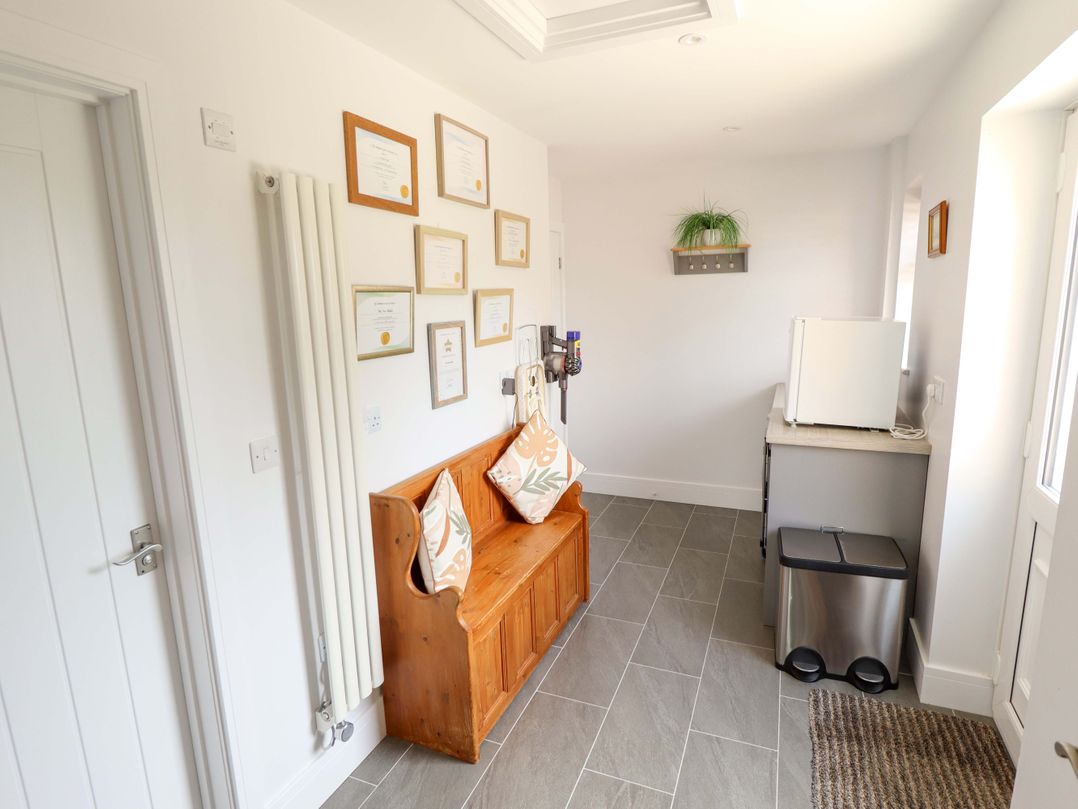 A utility room with certificates on the wall and a bench at The New Build in South Reston near Louth