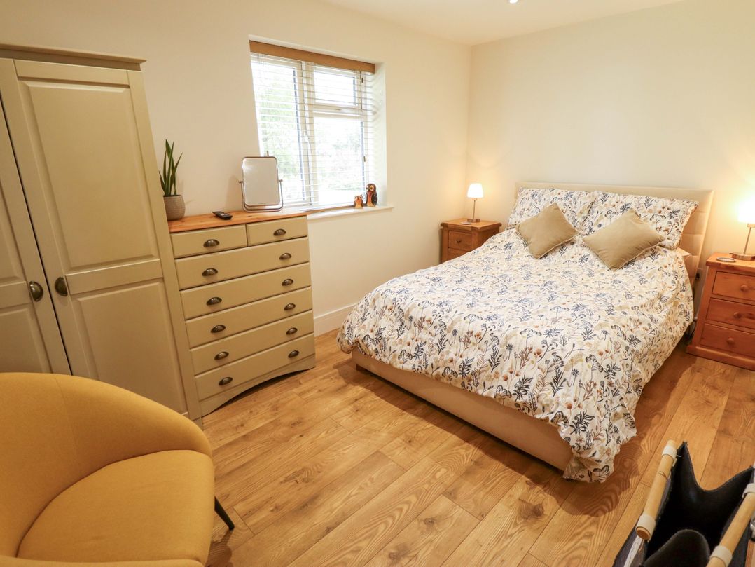 A bedroom with a bed and furniture at The New Build in South Reston near Louth