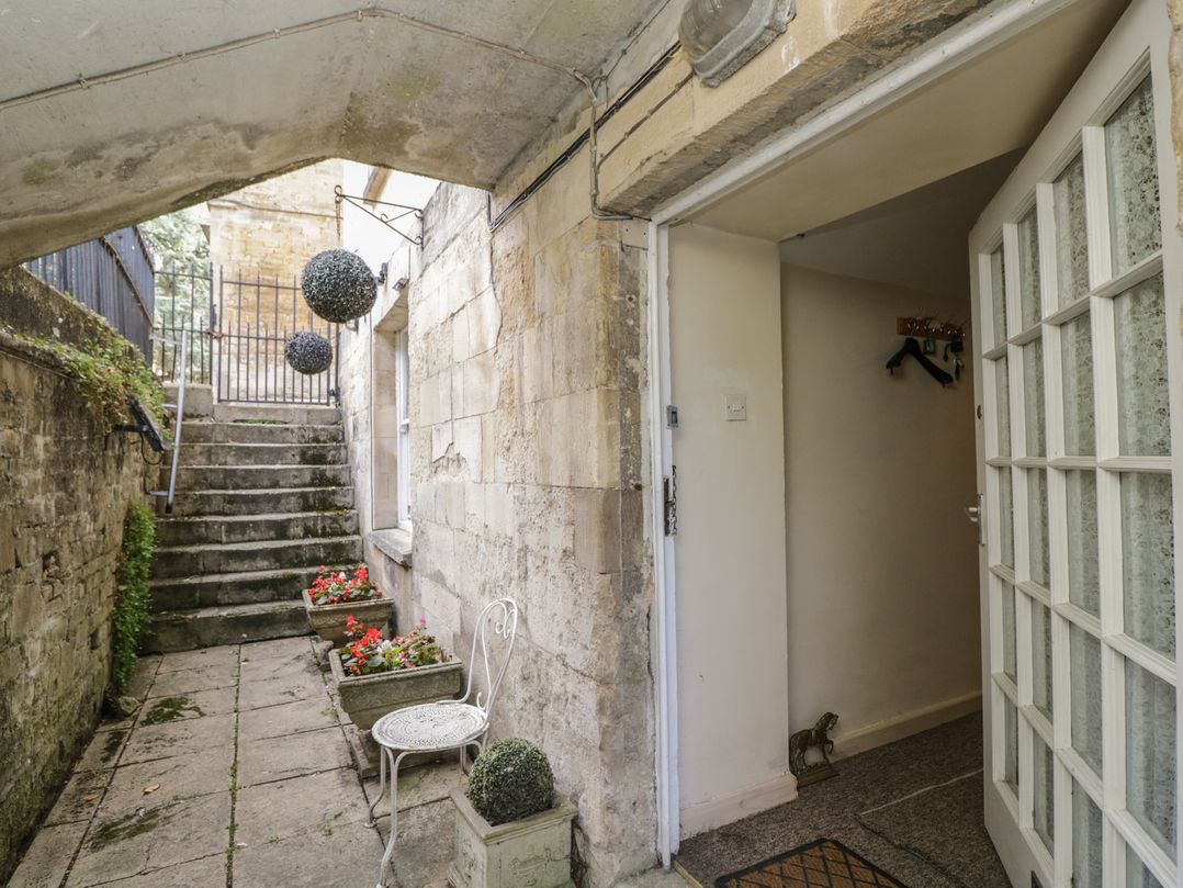 An outdoor entrance area with stairs and flower pots at Dollar Ward House Basement Cirencester