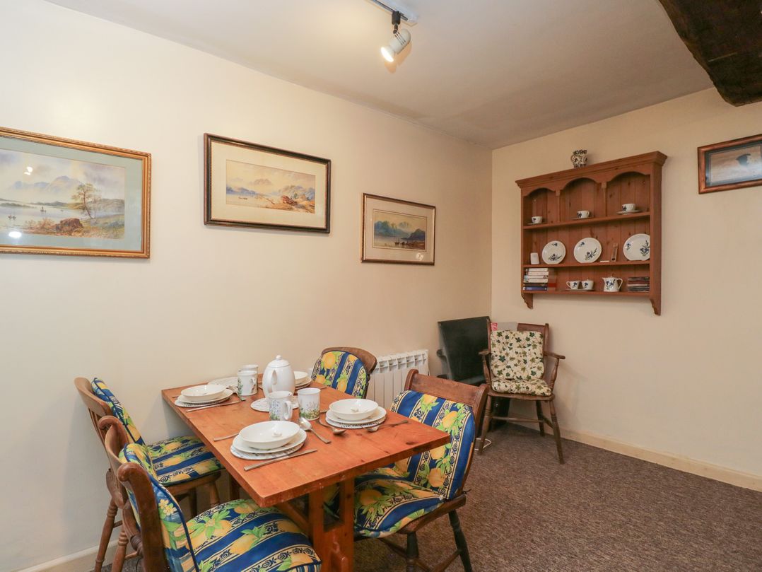 A dining room with a table and chairs at Dollar Ward House Basement Cirencester