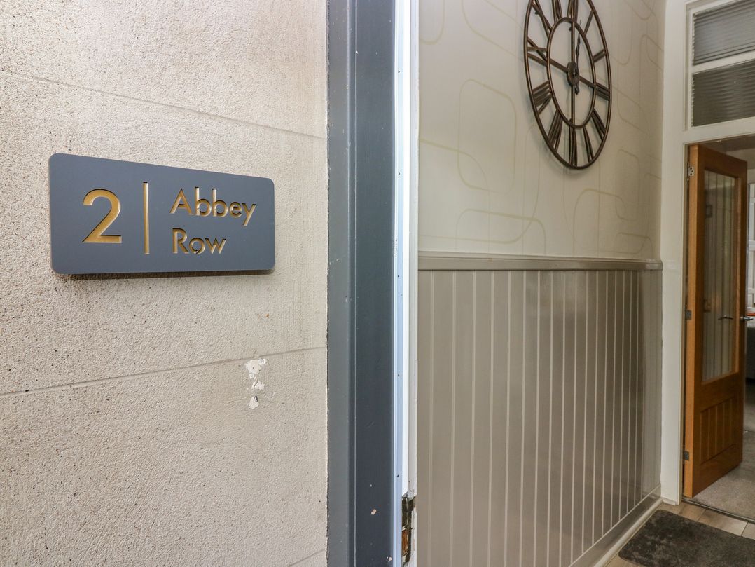 An entrance hall with a number sign and wall clock at 2 Abbey Row Kelso