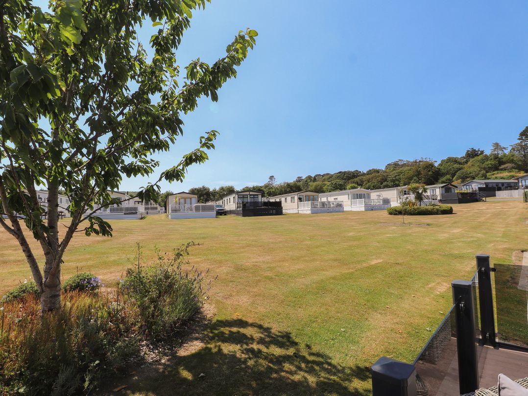 An outdoor view of holiday homes and grassy area at 97 Crugan Llanbedrog