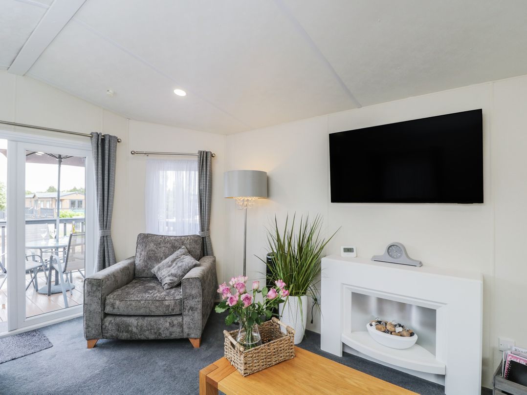 A living room with a sofa and television at The Cotswold Holiday Lodge Evesham