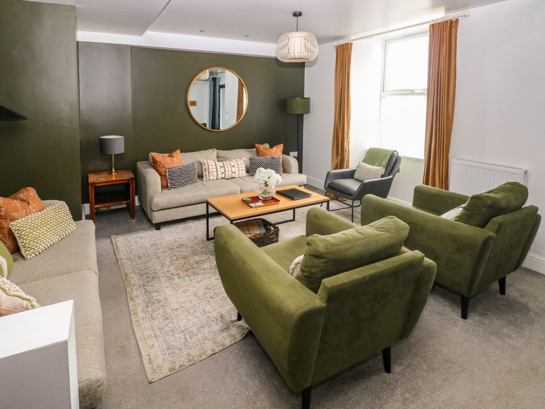 A living room with sofas and a coffee table at Teifi Villa in St Dogmaels
