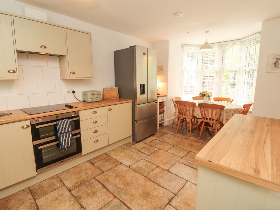 A kitchen with appliances and a dining area at The Old Post House at Low Stott Park near Newby Bridge