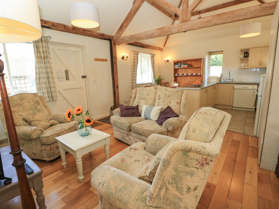 A living room with a sofa and coffee table at Byre Cottage 2 Sullington near Storrington