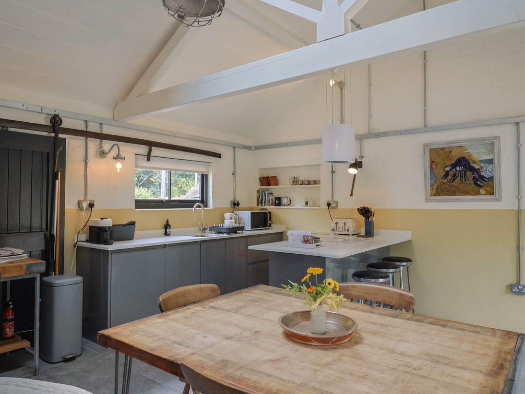 A kitchen with a table and chairs at The Dairy in Bridport