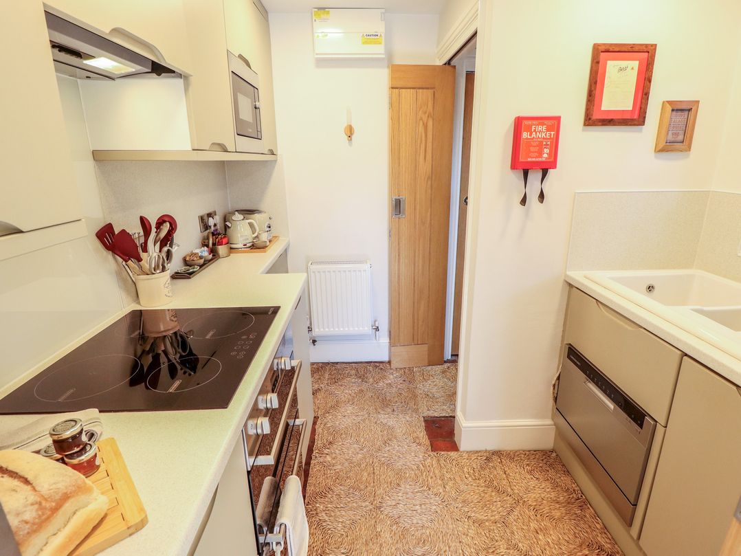 A kitchen with cooking appliances and utensils at Hangmans cottage in Horncastle