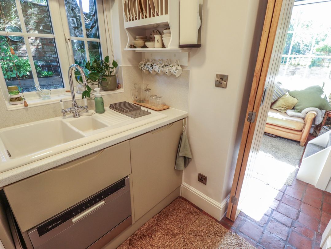 A kitchen with a sink and dishwasher at Hangmans cottage in Horncastle