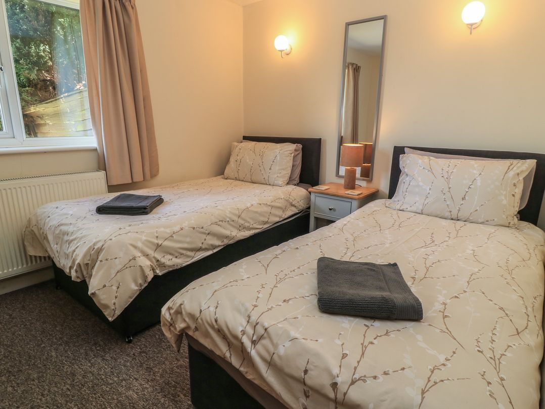 A bedroom with two single beds and a nightstand at Ryecross Farm Cottage in Shaftesbury