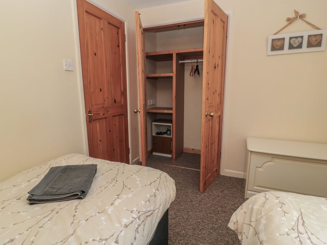 A bedroom with a bed and wardrobe at Ryecross Farm Cottage in Shaftesbury